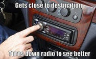 Turns down radio to see better