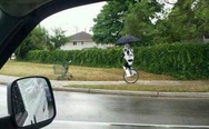 A stormtrooper unicycling in the rain