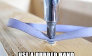 Use a rubber band to remove a stripped screw