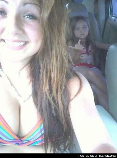 Photobomb. Daughter in the car showing a middle finger.