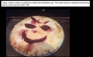 A smiley face blackberry pie