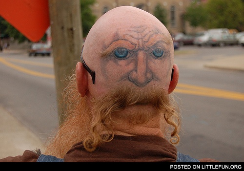 Bald head tattoo. The face with a mustache.