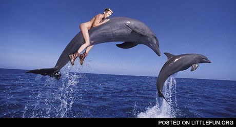 Miley Cyrus riding a dolphin