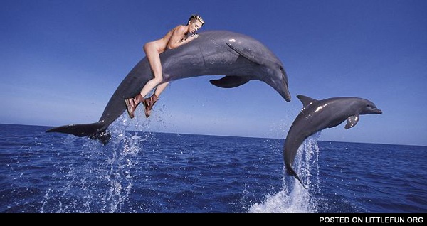 Miley Cyrus riding a dolphin